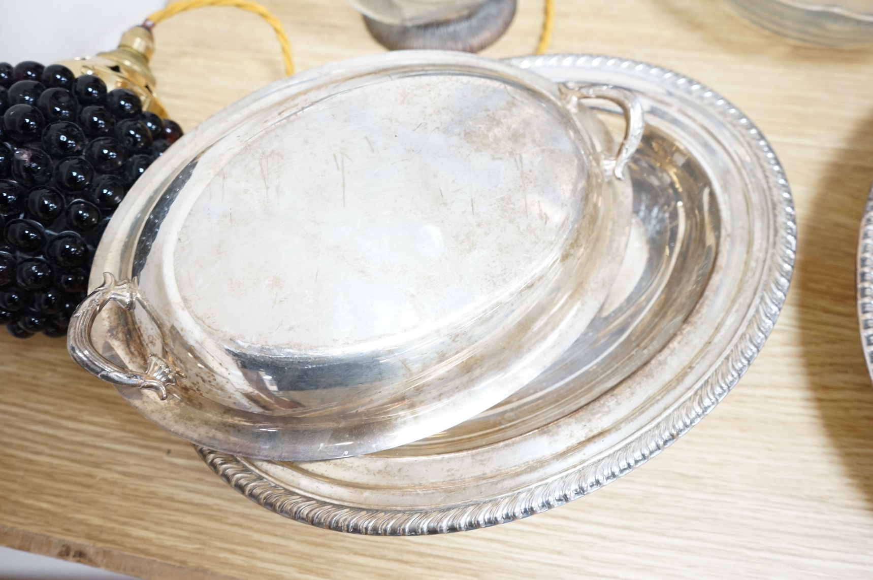 Silver plated ware to include a plated novelty duck decanter and two entree dishes and covers. Condition - fair